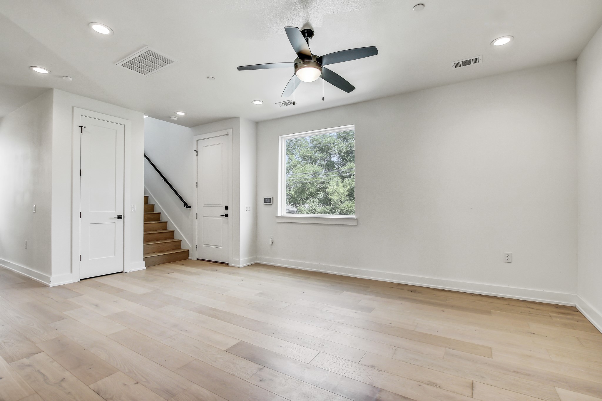 4127 East 12th Street, Unit 3 Austin, TX 78721 - Photo 9 of 29 an empty room with ceiling fan and windows
