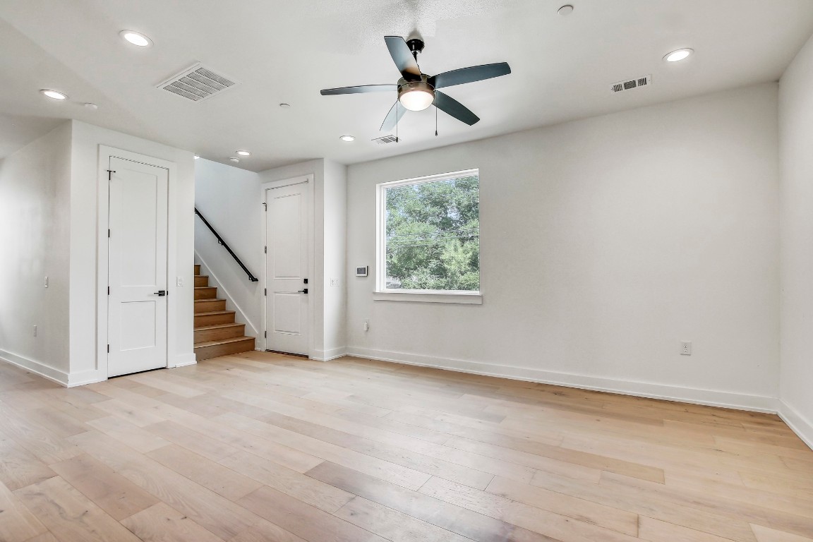 4127 East 12th Street, Unit 3 Austin, TX 78721 - Photo 9 of 29 an empty room with ceiling fan and windows