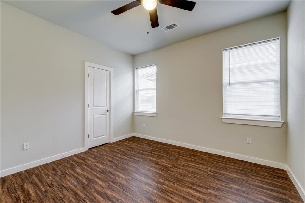 906 Quartz Court, Unit 601 Cedar Park, TX 78613 - Photo 9 of 15 a view of empty room with wooden floor and fan