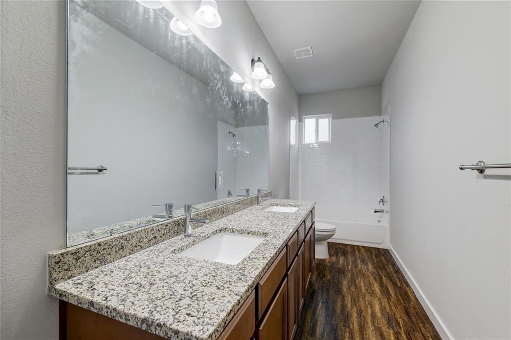 906 Quartz Court, Unit 601 Cedar Park, TX 78613 - Photo 11 of 15 a bathroom with a granite countertop sink and a mirror