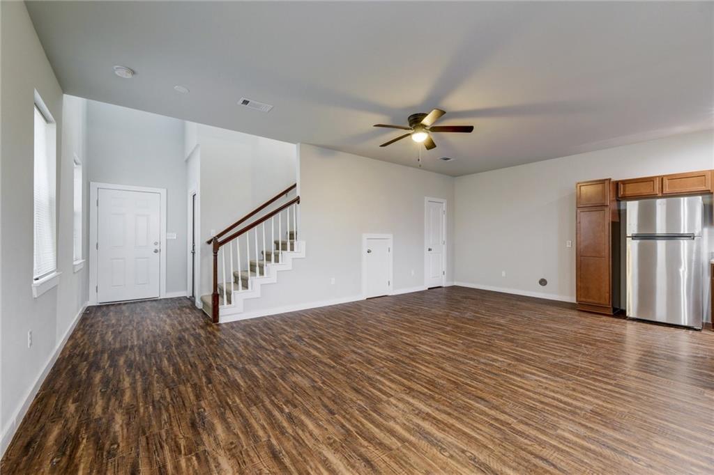 906 Quartz Court, Unit 601 Cedar Park, TX 78613 - Photo 2 of 15 a view of an empty room with a window and wooden floor