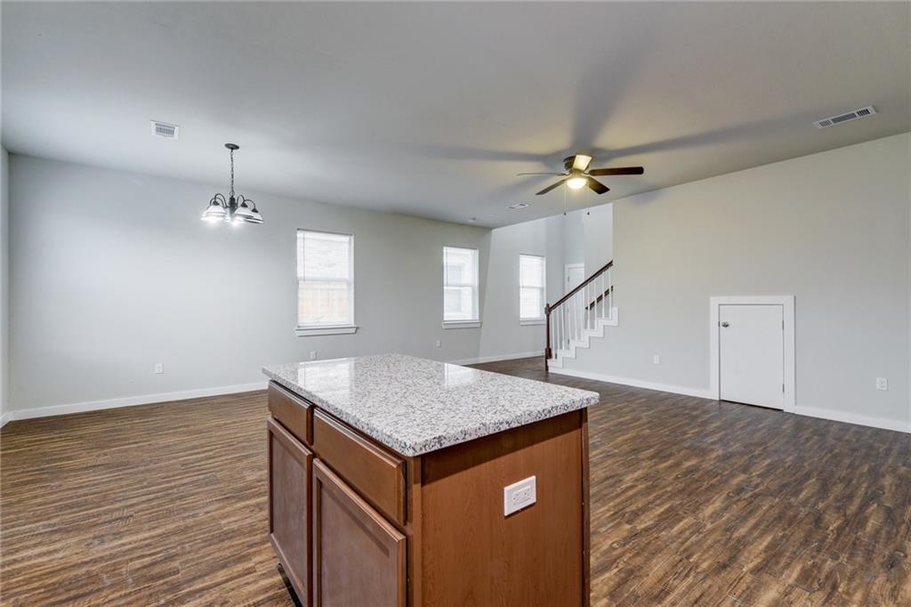 906 Quartz Court, Unit 601 Cedar Park, TX 78613 - Photo 15 of 15 an empty room with wooden floor and ceiling fan