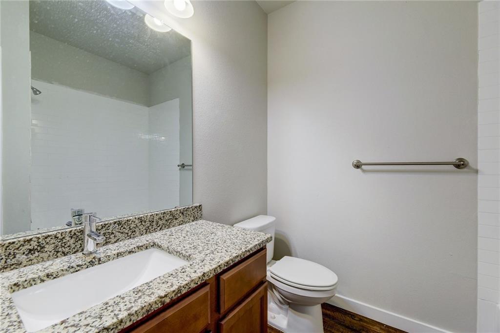 906 Quartz Court, Unit 601 Cedar Park, TX 78613 - Photo 6 of 15 a bathroom with a granite countertop sink a toilet and a mirror