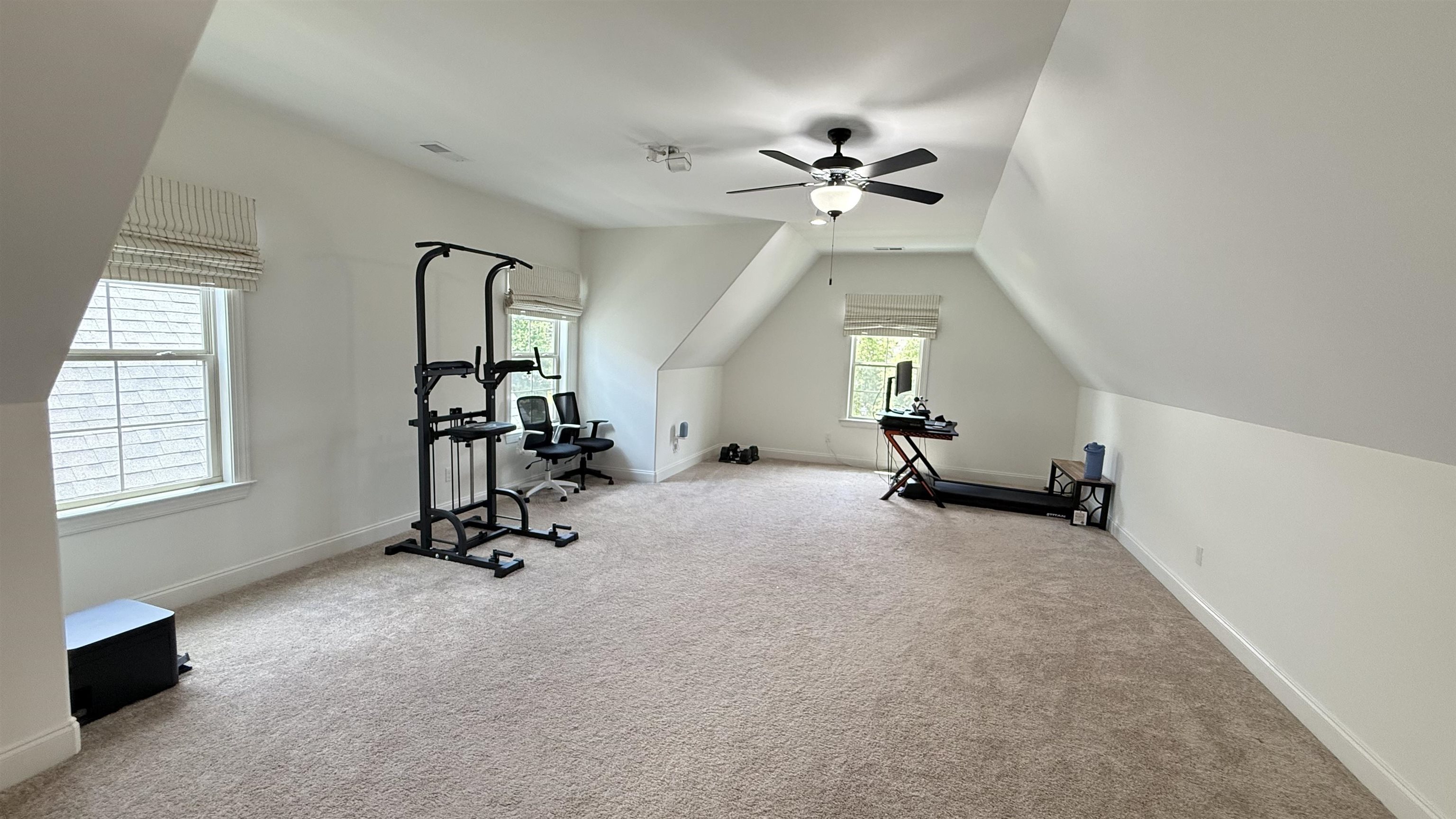 1746 Chadwick Farms Loop North Collierville, TN 38017 - Photo 21 of 35 Exercise room featuring ceiling fan, carpet flooring, and vaulted ceiling