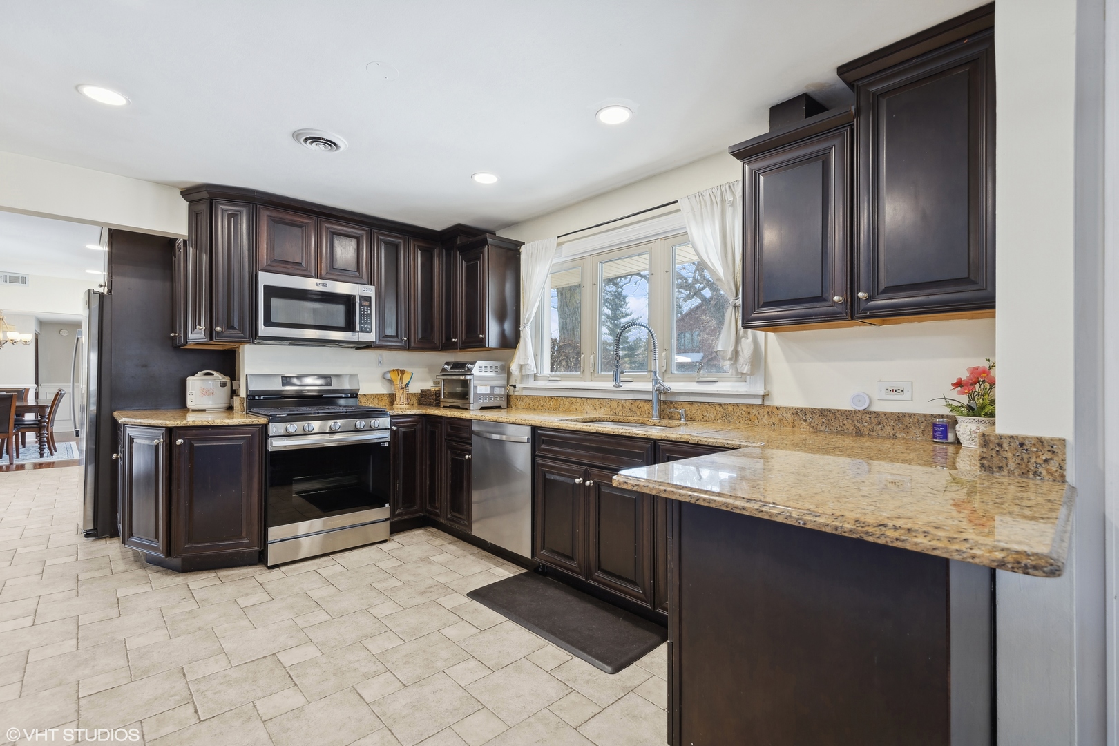 1115 Potter Road Park Ridge, IL 60068 - Photo 8 of 24 a kitchen with stainless steel appliances granite countertop a sink stove and refrigerator