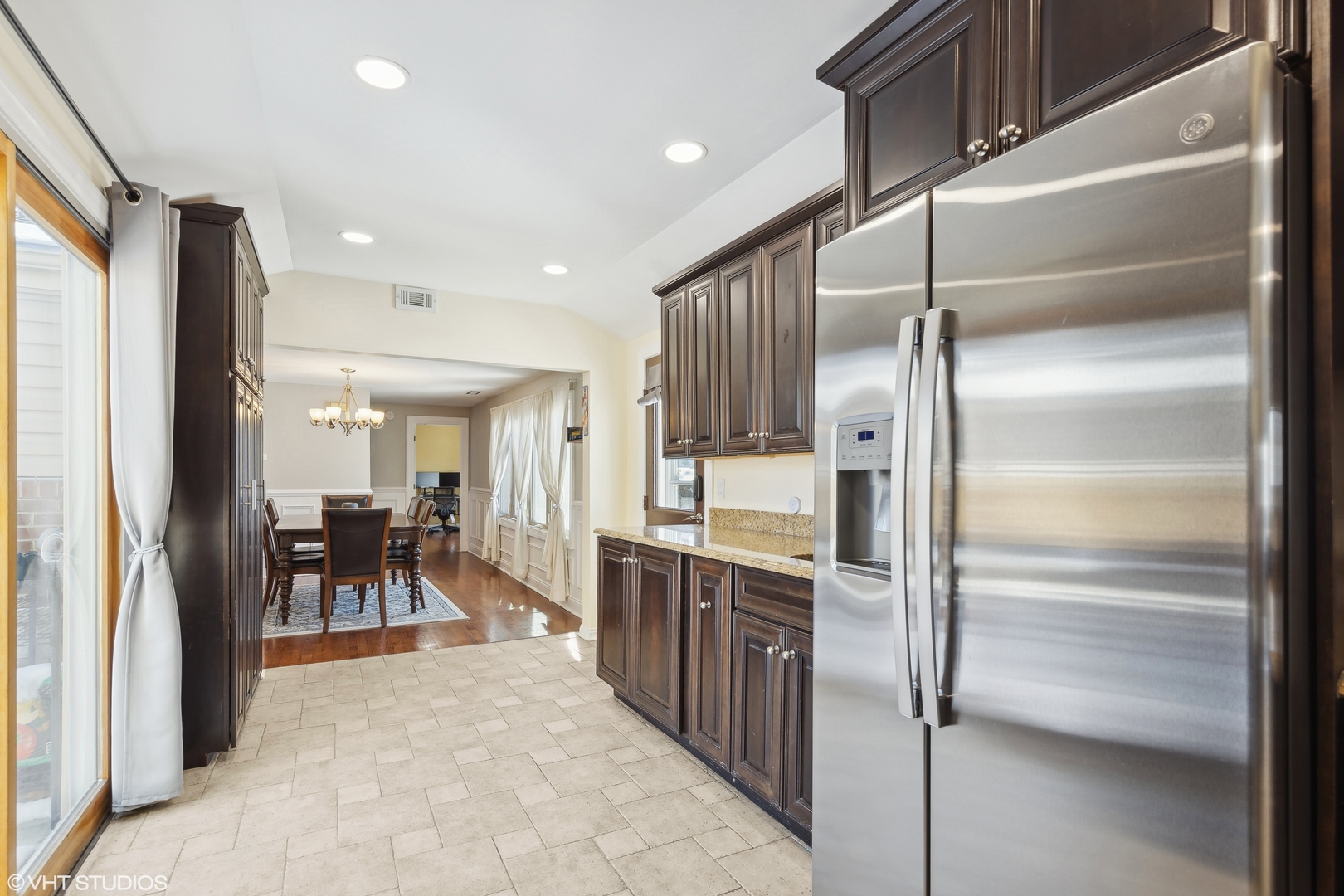 1115 Potter Road Park Ridge, IL 60068 - Photo 9 of 24 a kitchen with stainless steel appliances kitchen island granite countertop dining table chair and a refrigerator