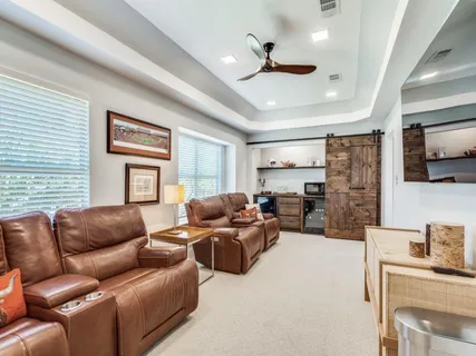 a living room with furniture ceiling fan and a window