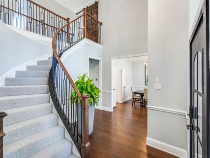 a view of entryway with wooden floor and stairs