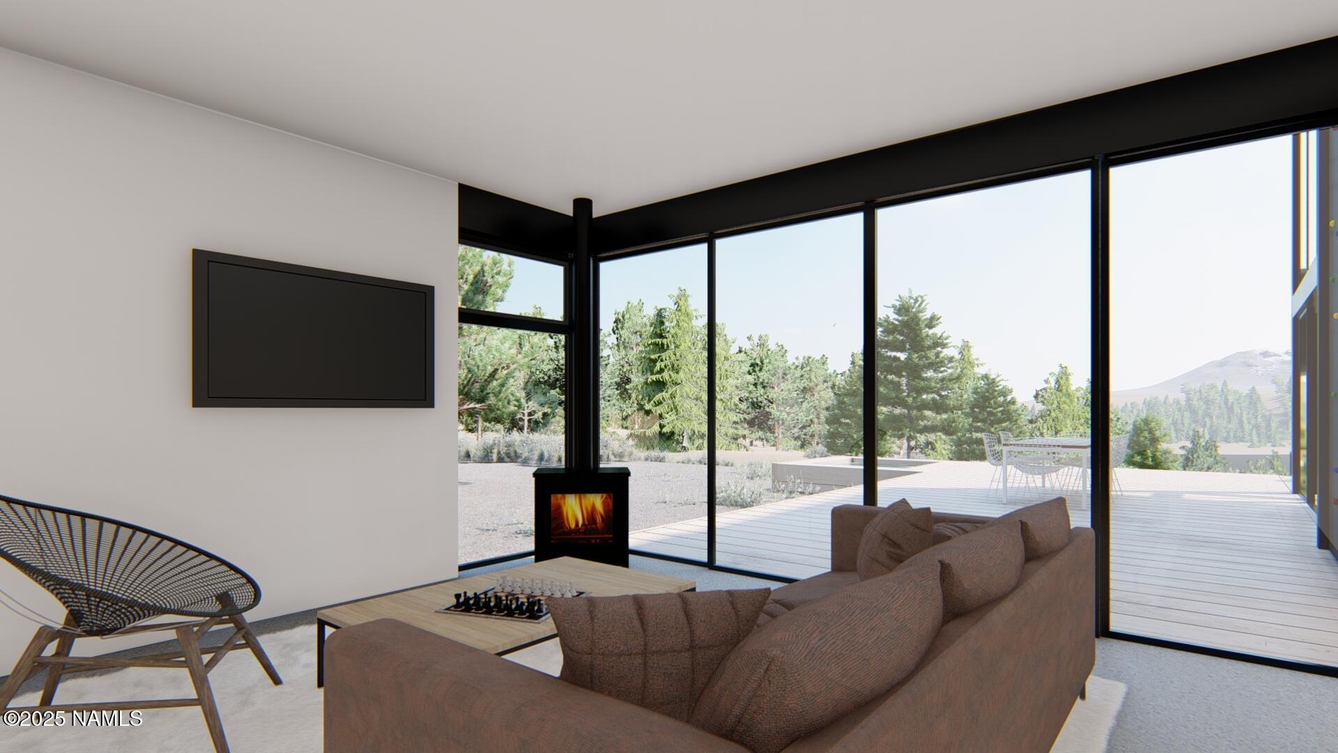 747 North Davenport Lk Road Williams, AZ 86046 - Photo 4 of 28 a living room with furniture tv and a floor to ceiling window