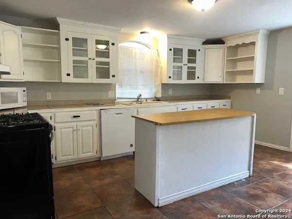 a utility room with cabinets washer and dryer