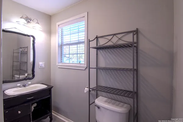 a bathroom with a sink vanity tub and a mirror