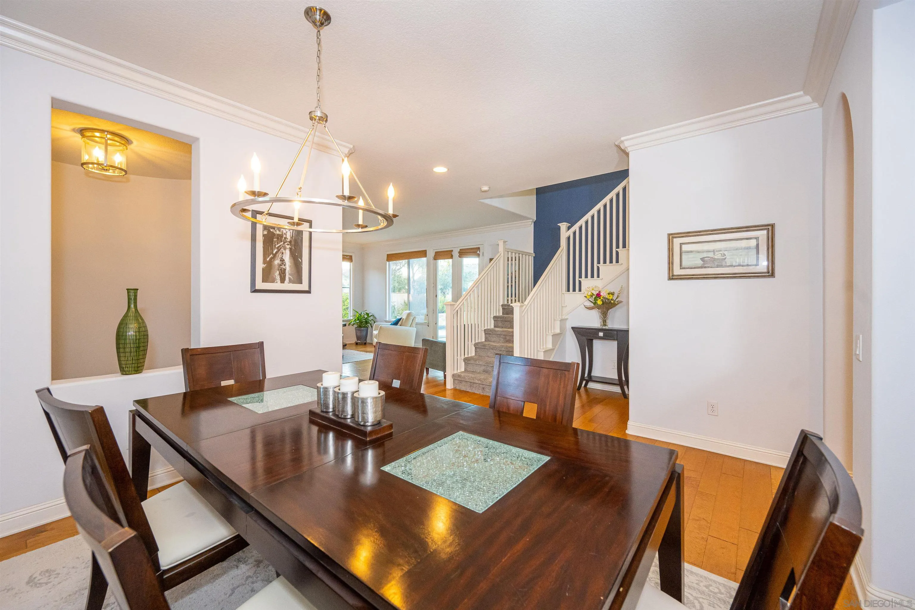 1540 Weatherly Road Carlsbad, CA 92011 - Photo 29 of 58 a view of a dining room with furniture a chandelier and wooden floor
