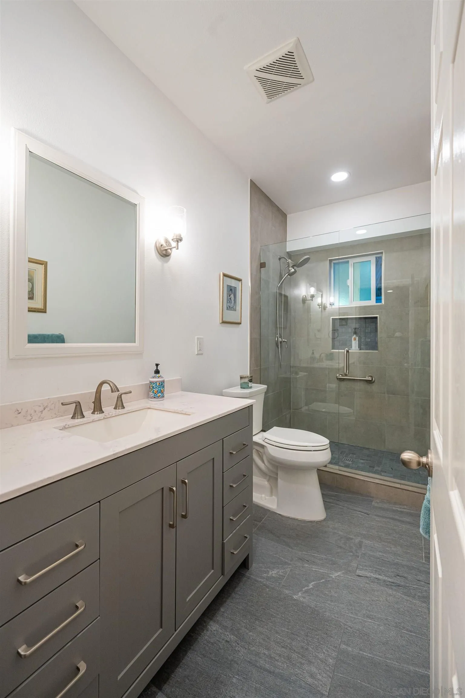 1540 Weatherly Road Carlsbad, CA 92011 - Photo 32 of 58 a bathroom with a double vanity sink toilet and shower