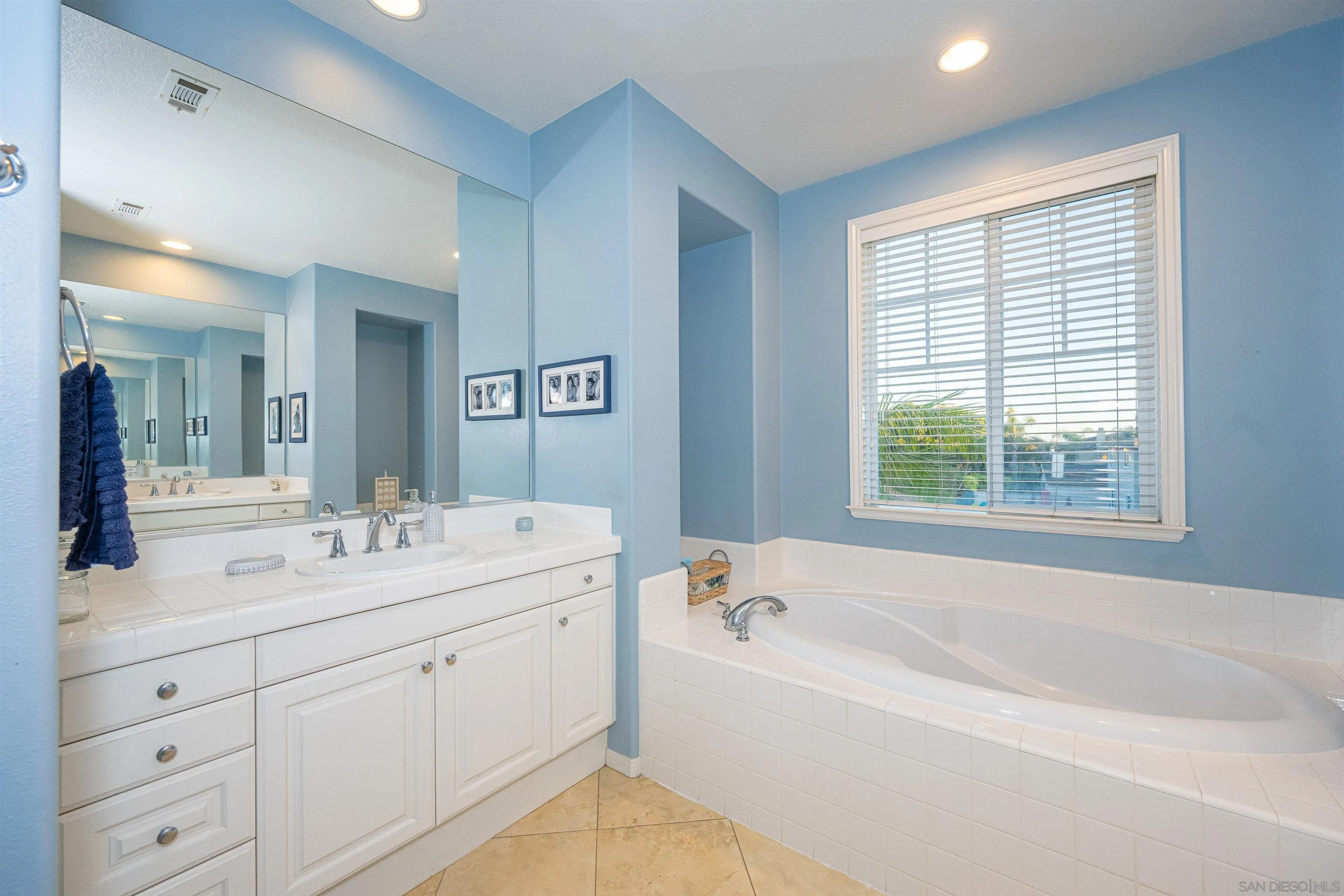 1540 Weatherly Road Carlsbad, CA 92011 - Photo 50 of 58 a bathroom with a tub a double vanity sink a window and a mirror