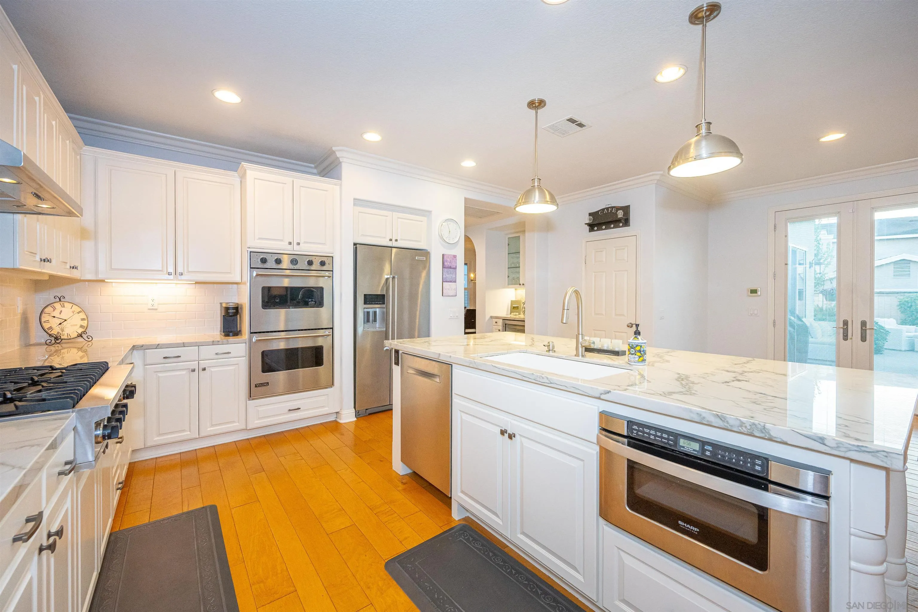 1540 Weatherly Road Carlsbad, CA 92011 - Photo 5 of 58 a kitchen with stainless steel appliances granite countertop a sink a stove and a refrigerator
