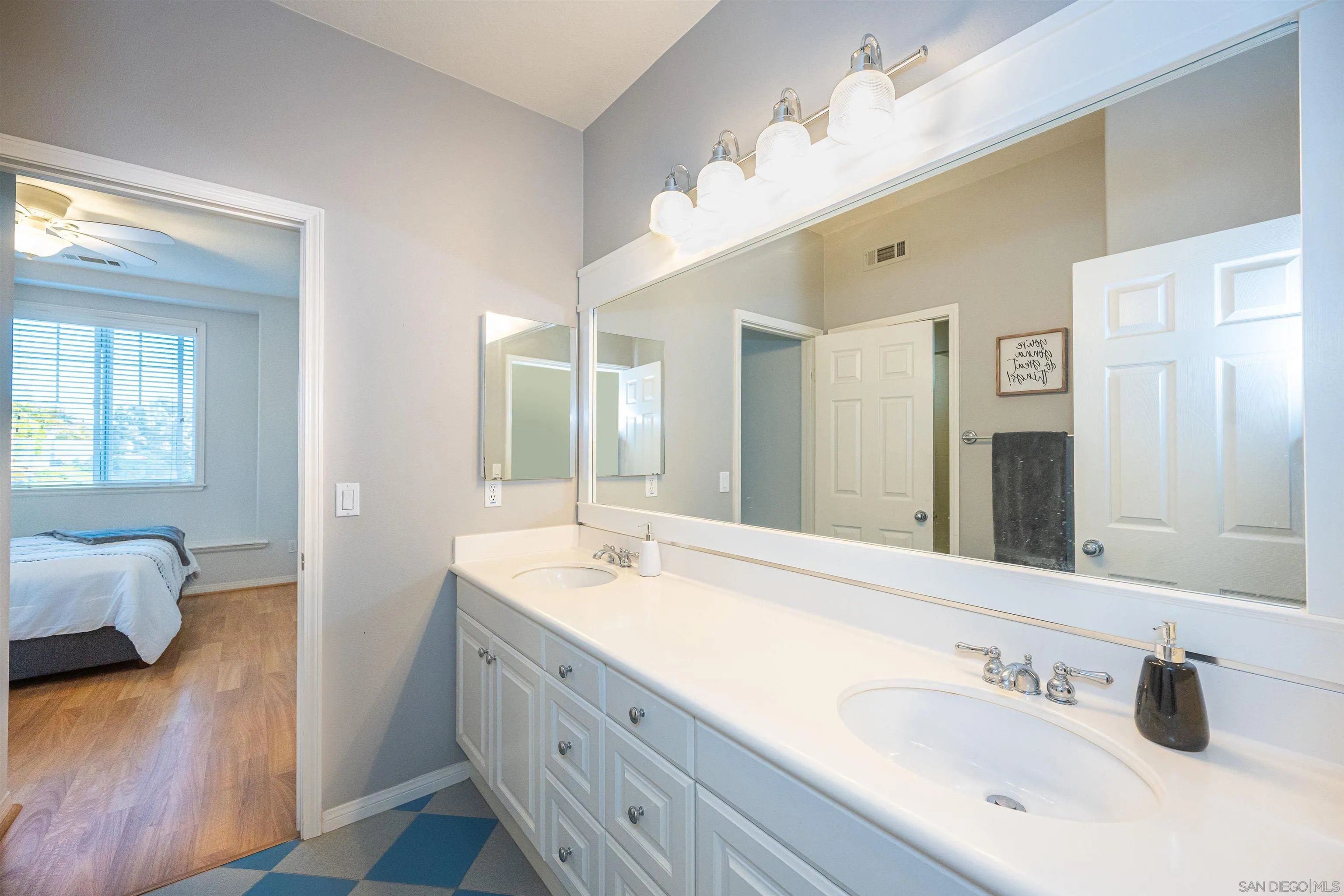 1540 Weatherly Road Carlsbad, CA 92011 - Photo 53 of 58 a en suite bathroom with double vanity and a mirror