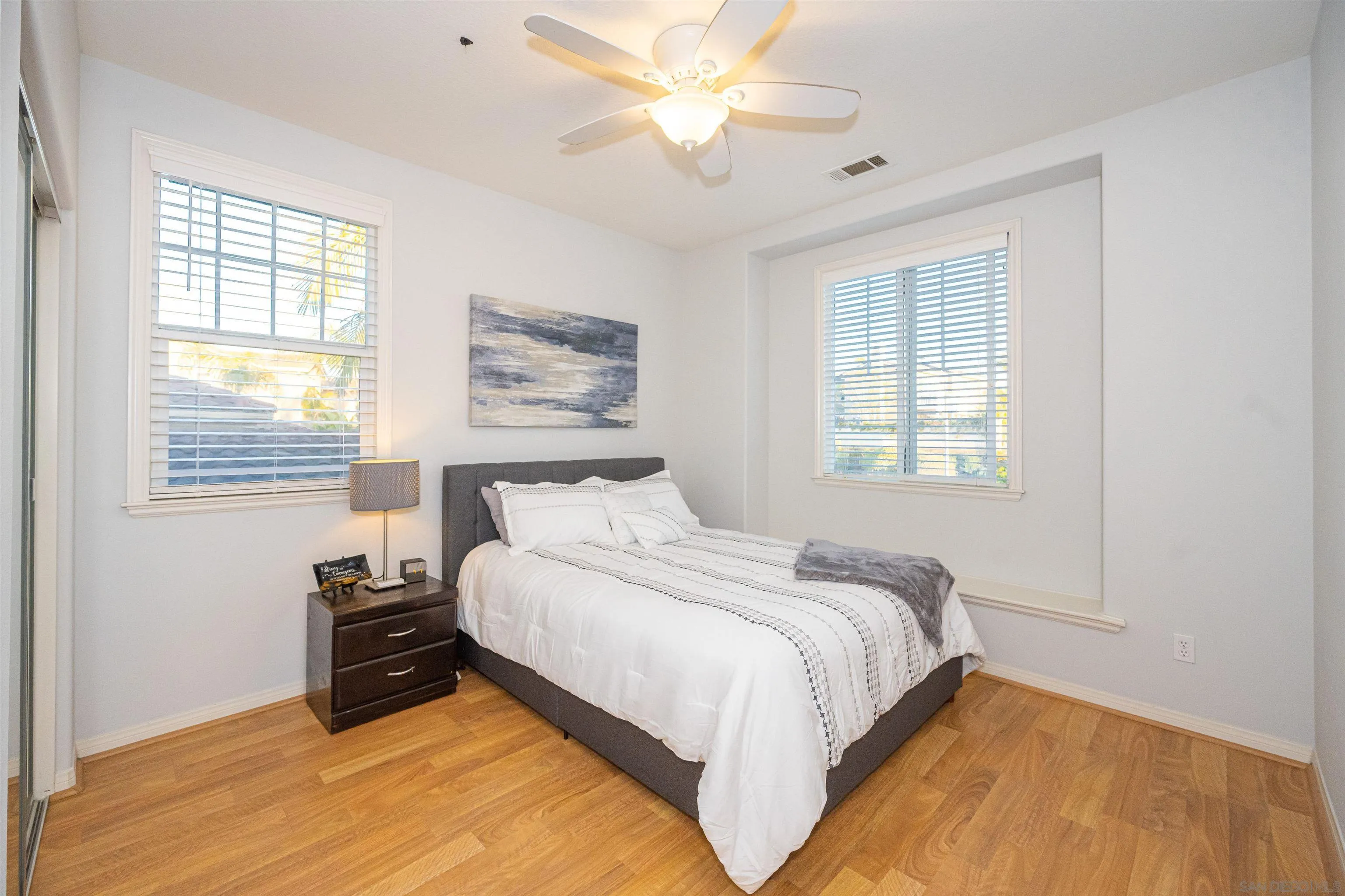 1540 Weatherly Road Carlsbad, CA 92011 - Photo 55 of 58 a bedroom with a bed and wooden floor