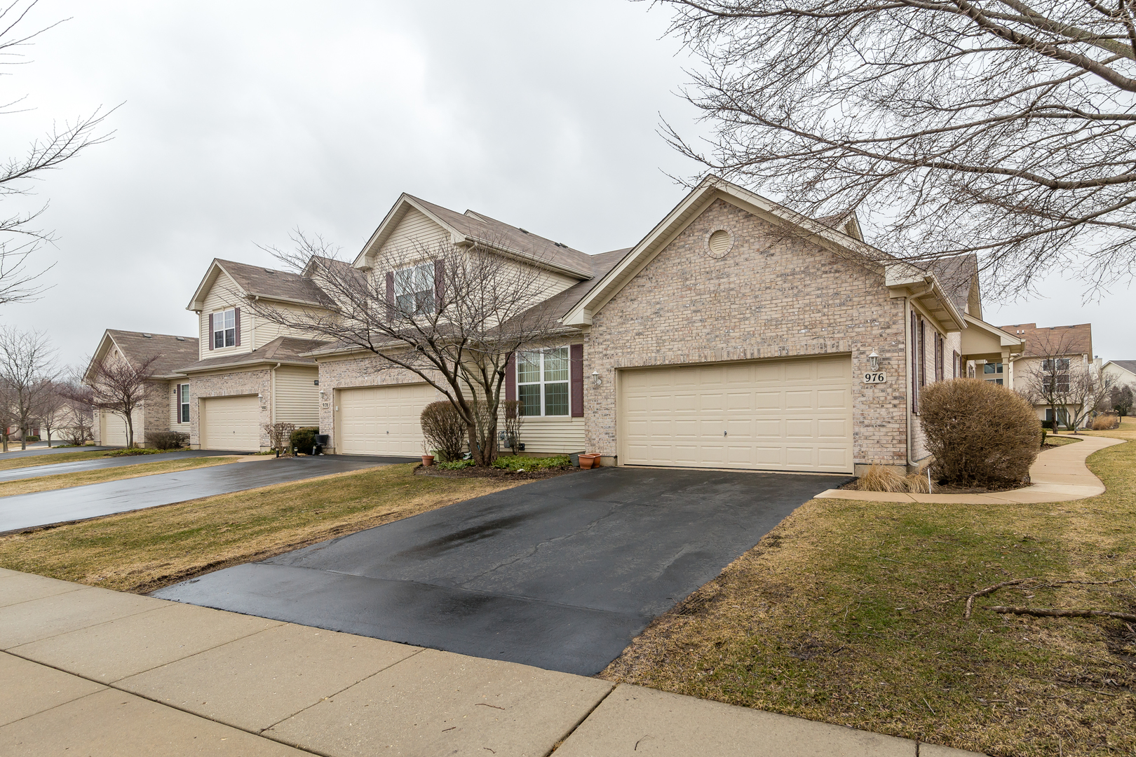 976 Oak Ridge Boulevard Elgin, IL 60120 - Photo 2 of 39 a view of a house with a yard and garage
