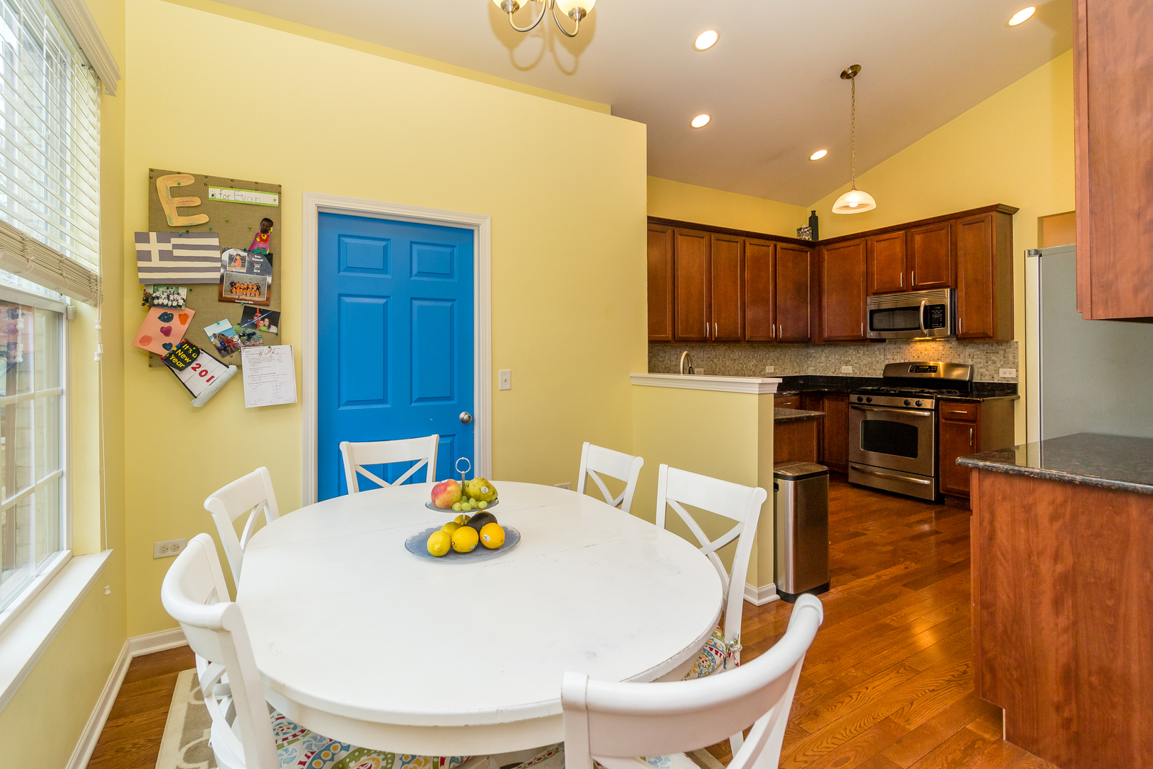 976 Oak Ridge Boulevard Elgin, IL 60120 - Photo 15 of 39 a kitchen with stainless steel appliances a dining table chairs and a refrigerator