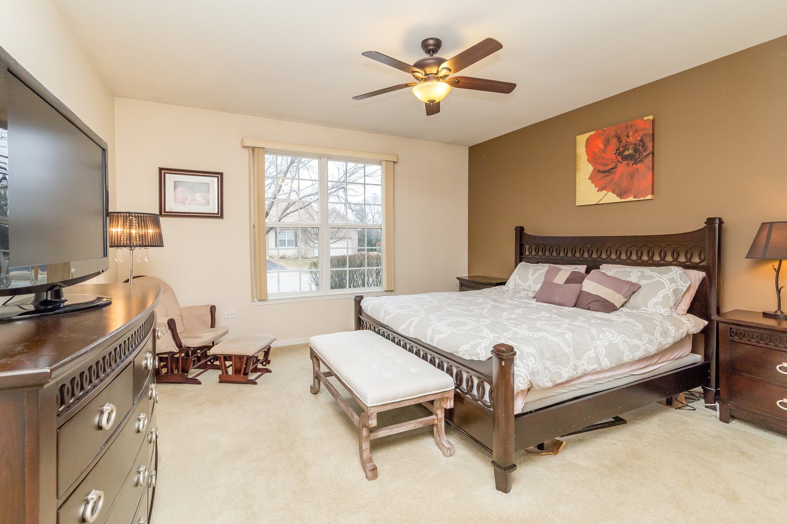 976 Oak Ridge Boulevard Elgin, IL 60120 - Photo 16 of 39 a bedroom with a bed and a chandelier