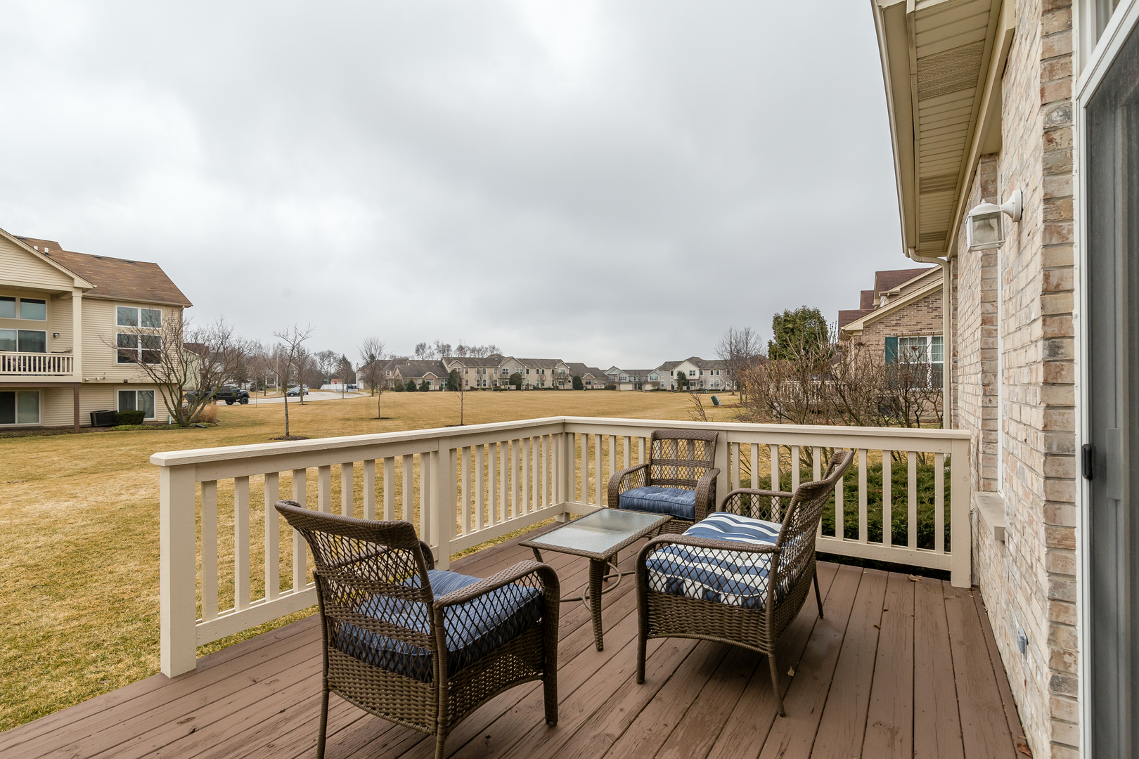 976 Oak Ridge Boulevard Elgin, IL 60120 - Photo 29 of 39 a view of a balcony with two chairs and wooden floor