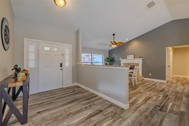 a view of a kitchen with furniture and wooden floor