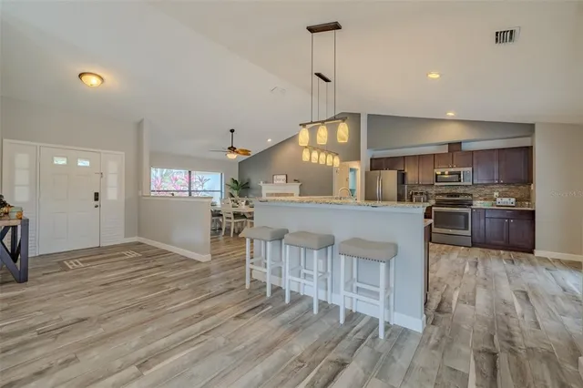 a living room with furniture a ceiling fan and a rug