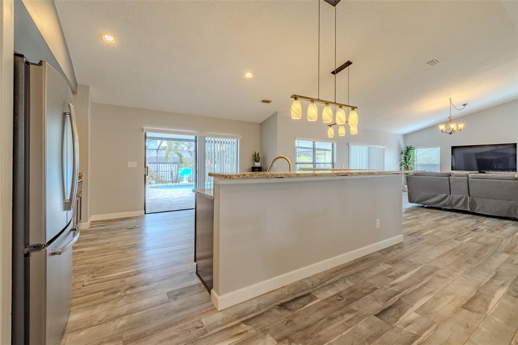 222 Halton Circle Seffner, FL 33584 - Photo 20 of 57 a kitchen with stainless steel appliances granite countertop a refrigerator a sink dishwasher a stove and white countertops with wooden floor