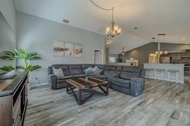 a bedroom with a bed chandelier and a window