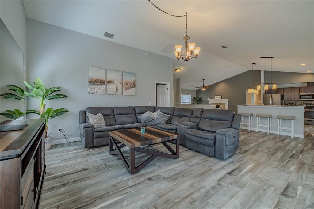 222 Halton Circle Seffner, FL 33584 - Photo 22 of 57 a living room with furniture kitchen view and a chandelier
