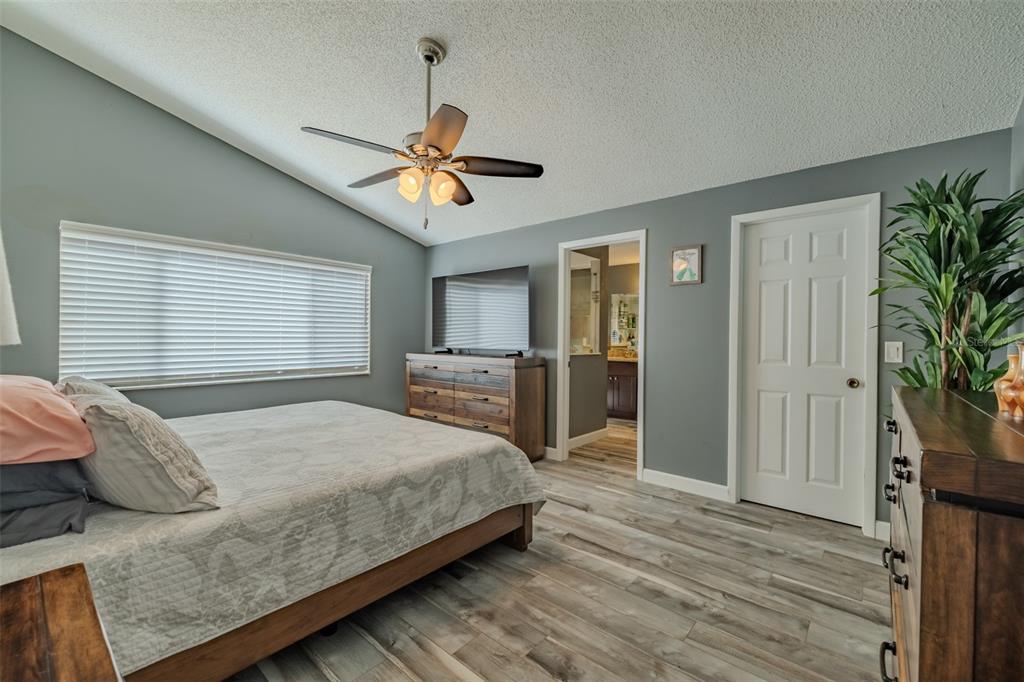 222 Halton Circle Seffner, FL 33584 - Photo 26 of 57 a bedroom with a bed and a chandelier
