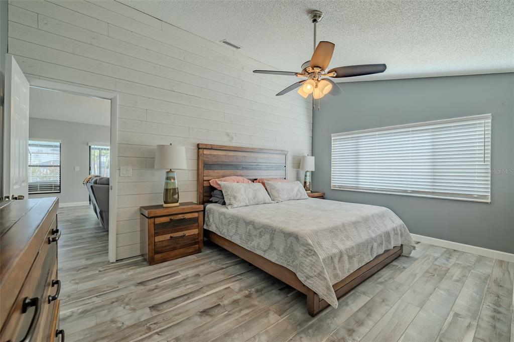 222 Halton Circle Seffner, FL 33584 - Photo 27 of 57 a bedroom with a bed chandelier and a window