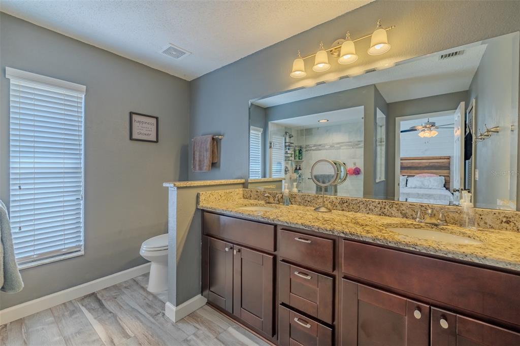 222 Halton Circle Seffner, FL 33584 - Photo 31 of 57 a bathroom with a granite countertop sink and a mirror