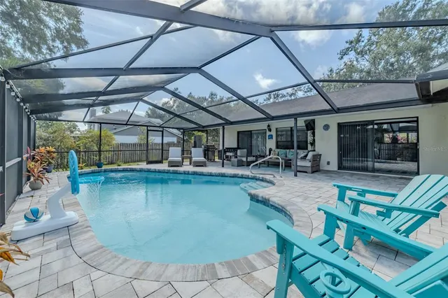 a view of a house with backyard porch and sitting area