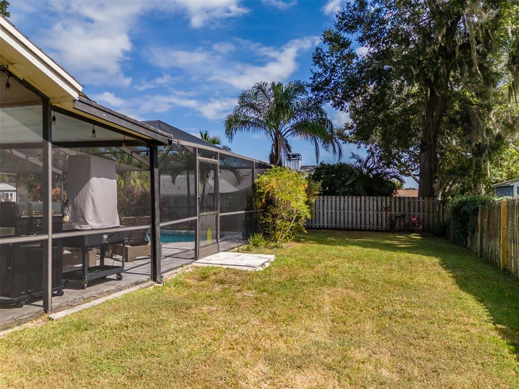 222 Halton Circle Seffner, FL 33584 - Photo 55 of 57 a view of backyard with wooden fence and a large tree