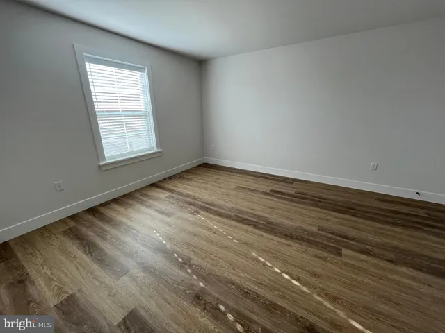 a view of an empty room and wooden floor
