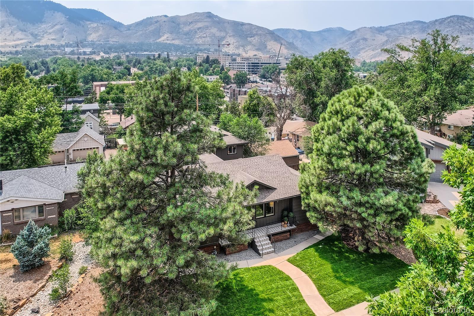 an aerial view of a house with yard and outdoor seating