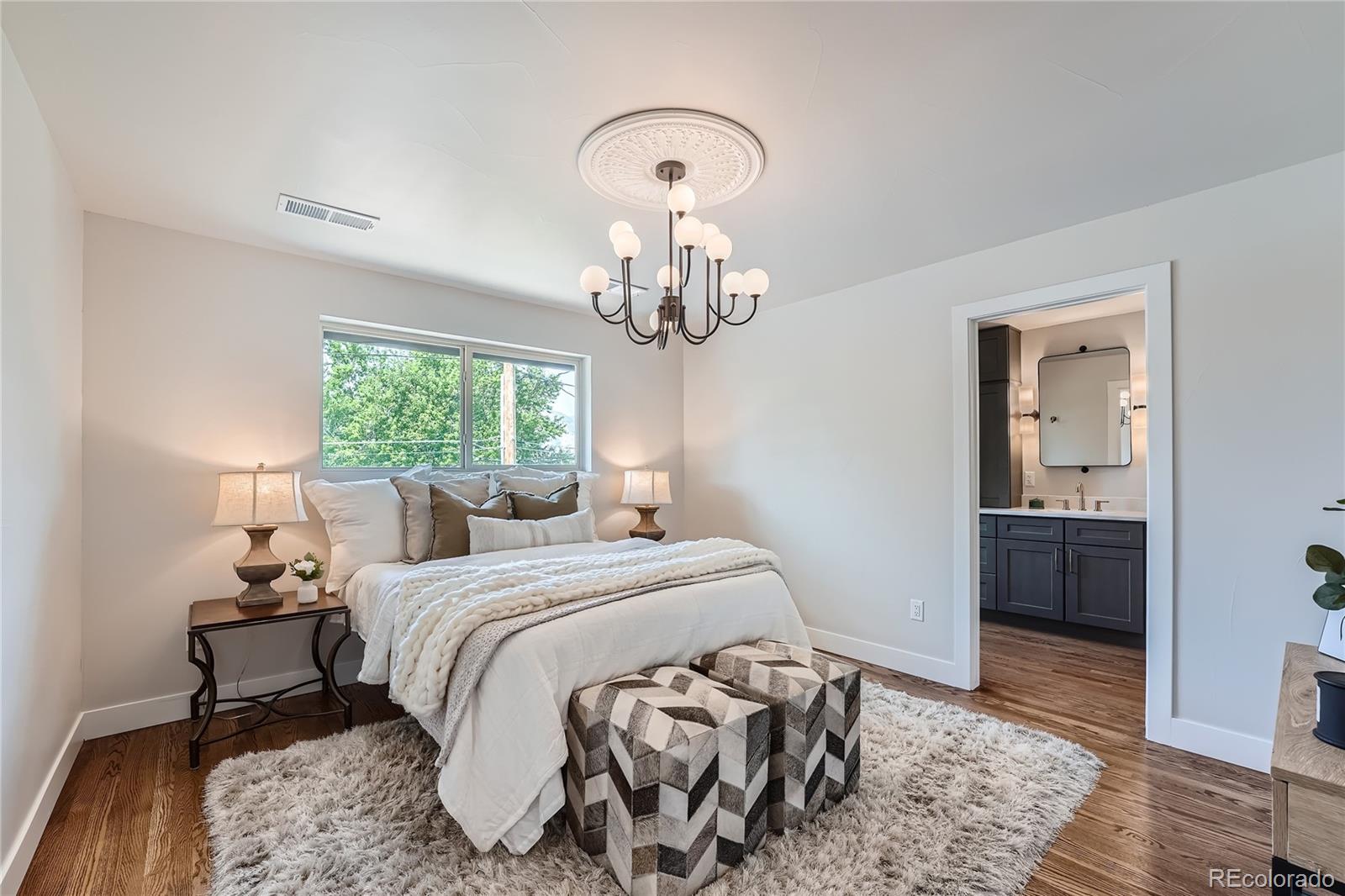 1908 East Street Golden, CO 80401 - Photo 20 of 50 a bedroom with a bed and a chandelier