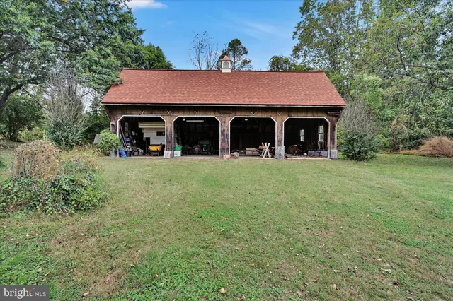 a front view of house with yard and trees in the background