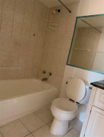 a bathroom with a toilet and bathtub