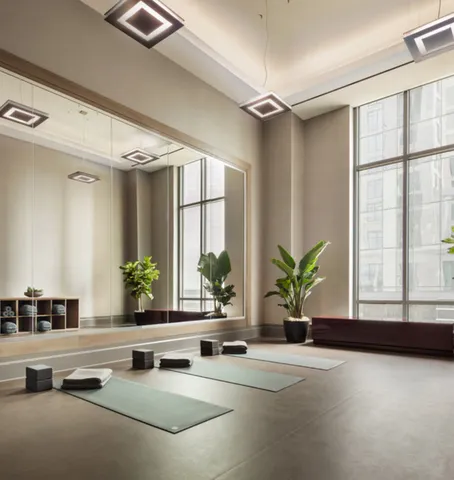 a living room with furniture and potted plants next to a large window