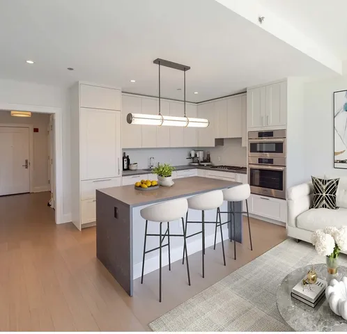 a kitchen with stainless steel appliances granite countertop a sink and white cabinets