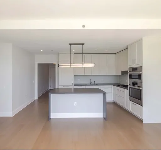 a kitchen with a stove a sink and a refrigerator