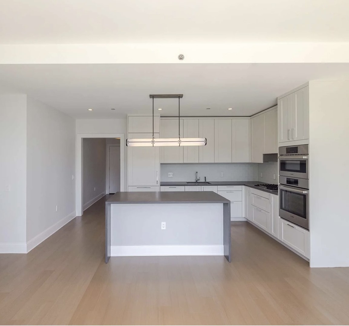 514 North Peshtigo Court, Unit 3307 Chicago, IL 60611 - Photo 7 of 30 a kitchen with stainless steel appliances granite countertop a sink and white cabinets