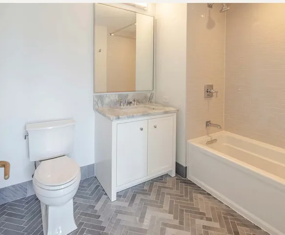 a bathroom with a sink a toilet and bathtub