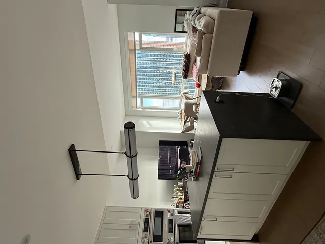 a spacious bedroom with a large bed and a large window