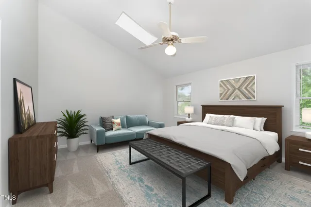 a bedroom with a large bed and a chandelier