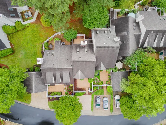 an aerial view of multiple houses with yard