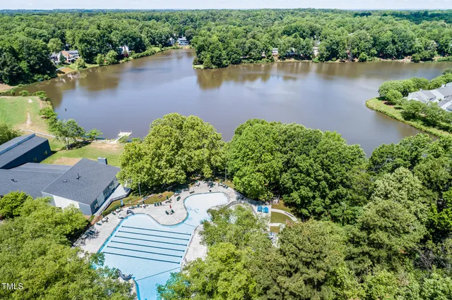 an aerial view of a house with outdoor space and lake view