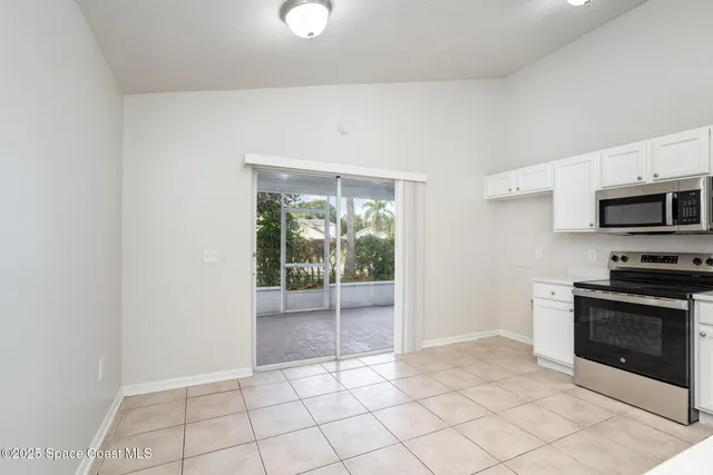 a view of a kitchen with a sink dishwasher and a fireplace